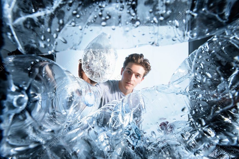 A person responsibly disposing of an old water bottle, emphasizing the importance of replacing water bottles regularly.