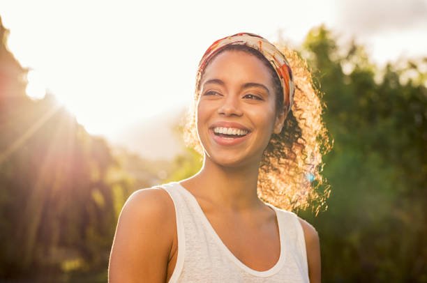 A woman confidently enjoying the sun with proper SPF protection.