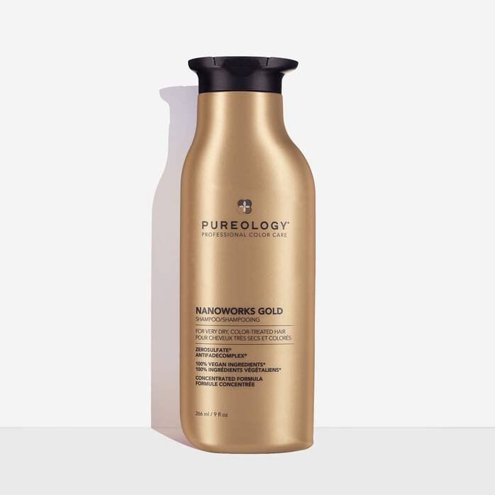 A bottle of Pureology Nanoworks Gold Hydrating Shampoo against a white background.