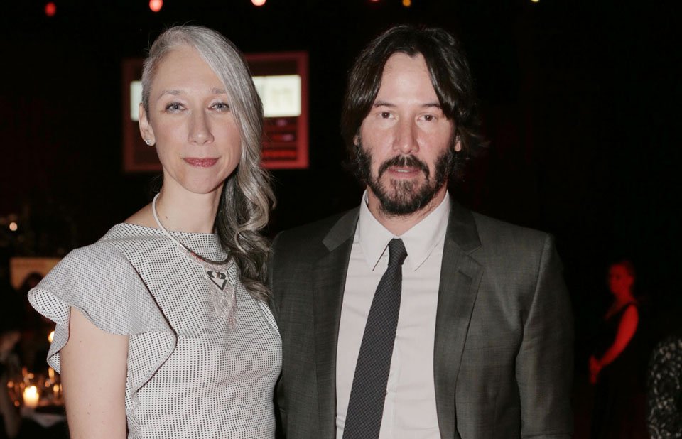 Keanu Reeves and Alexandra Grant posing for a photo at the UNAIDS Gala in 2016.