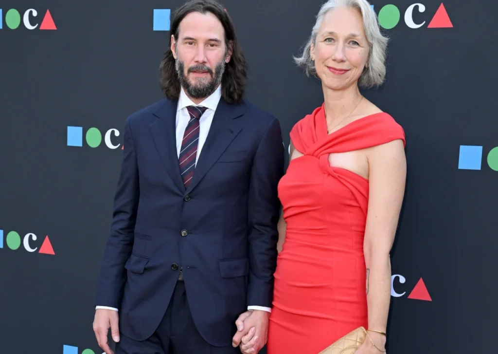 Keanu Reeves and Alexandra Grant smiling at each other at the MOCA Benefit.