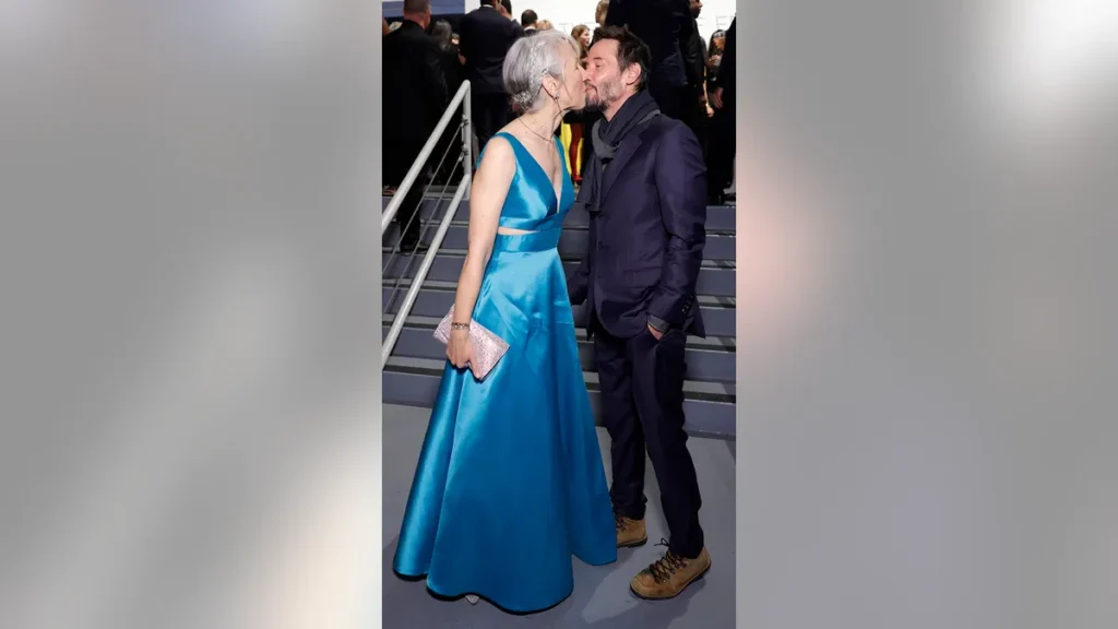 Keanu Reeves and Alexandra Grant sharing a kiss at the 2024 MOCA Gala.