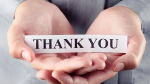 Two hands gently hold a paper strip that reads "Thank You."