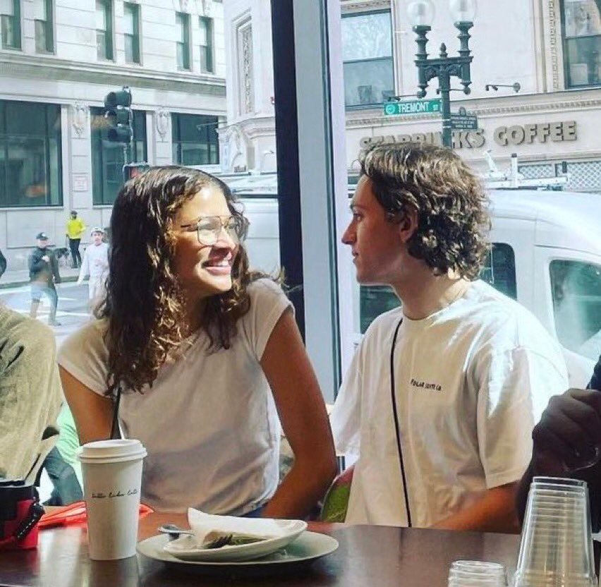 Zendaya gazing lovingly at Tom Holland during a coffee date in Boston.