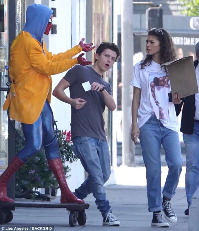 Tom Holland and Zendaya browsing comics together at a comic book store.