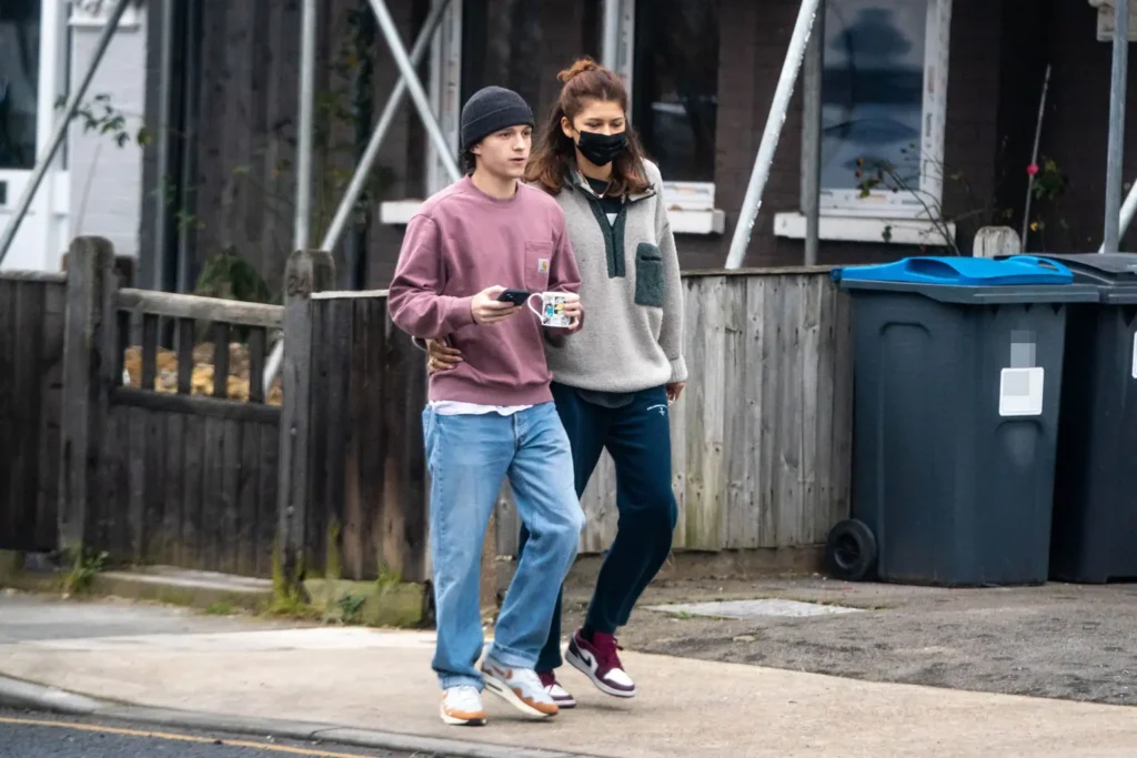 Tom Holland and Zendaya walking together in London.